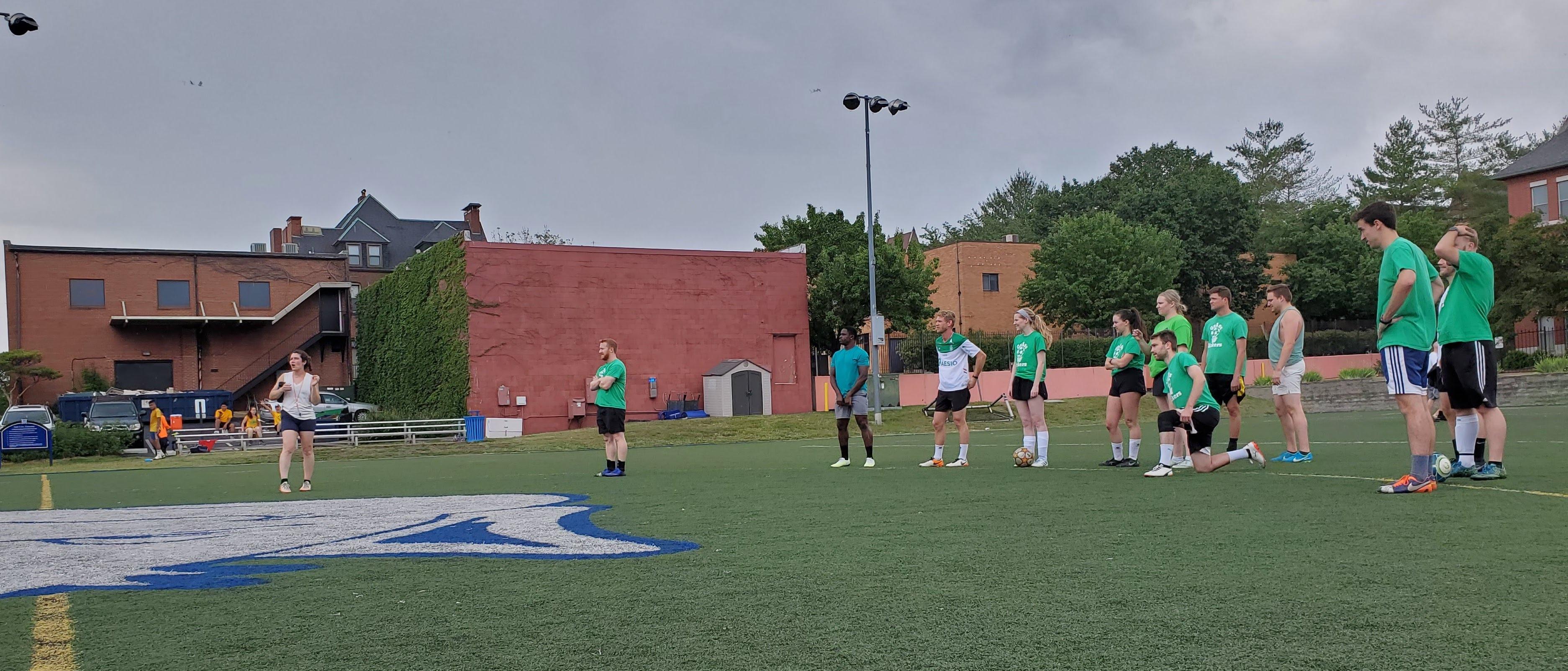 People playing Soccer in a field