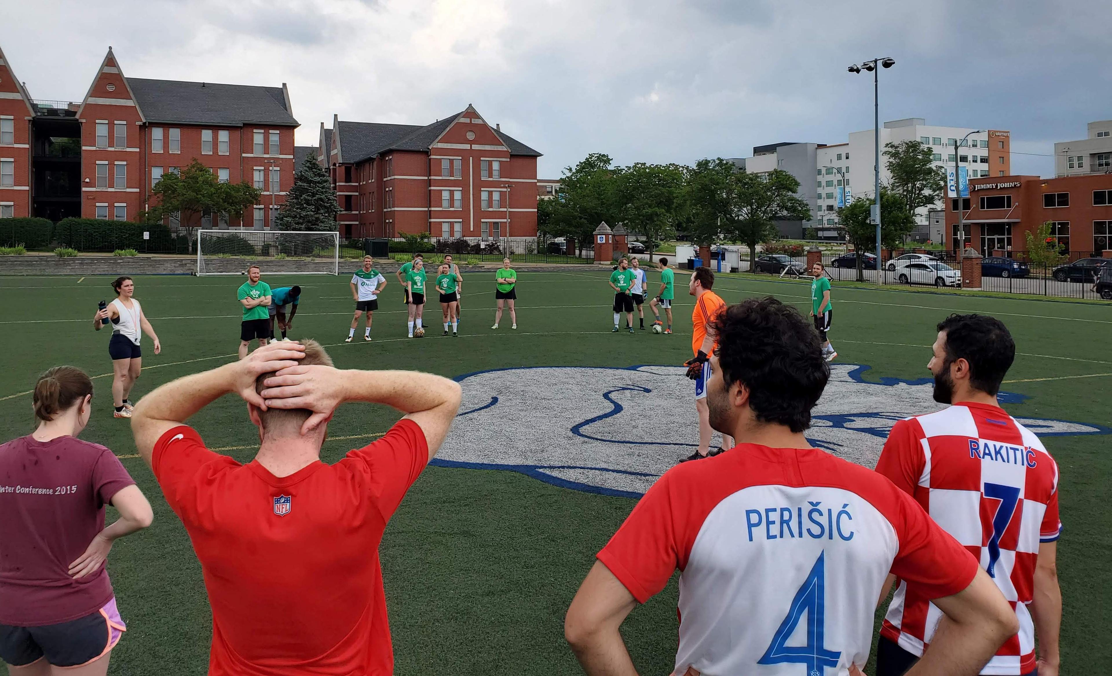 People playing Soccer in a field