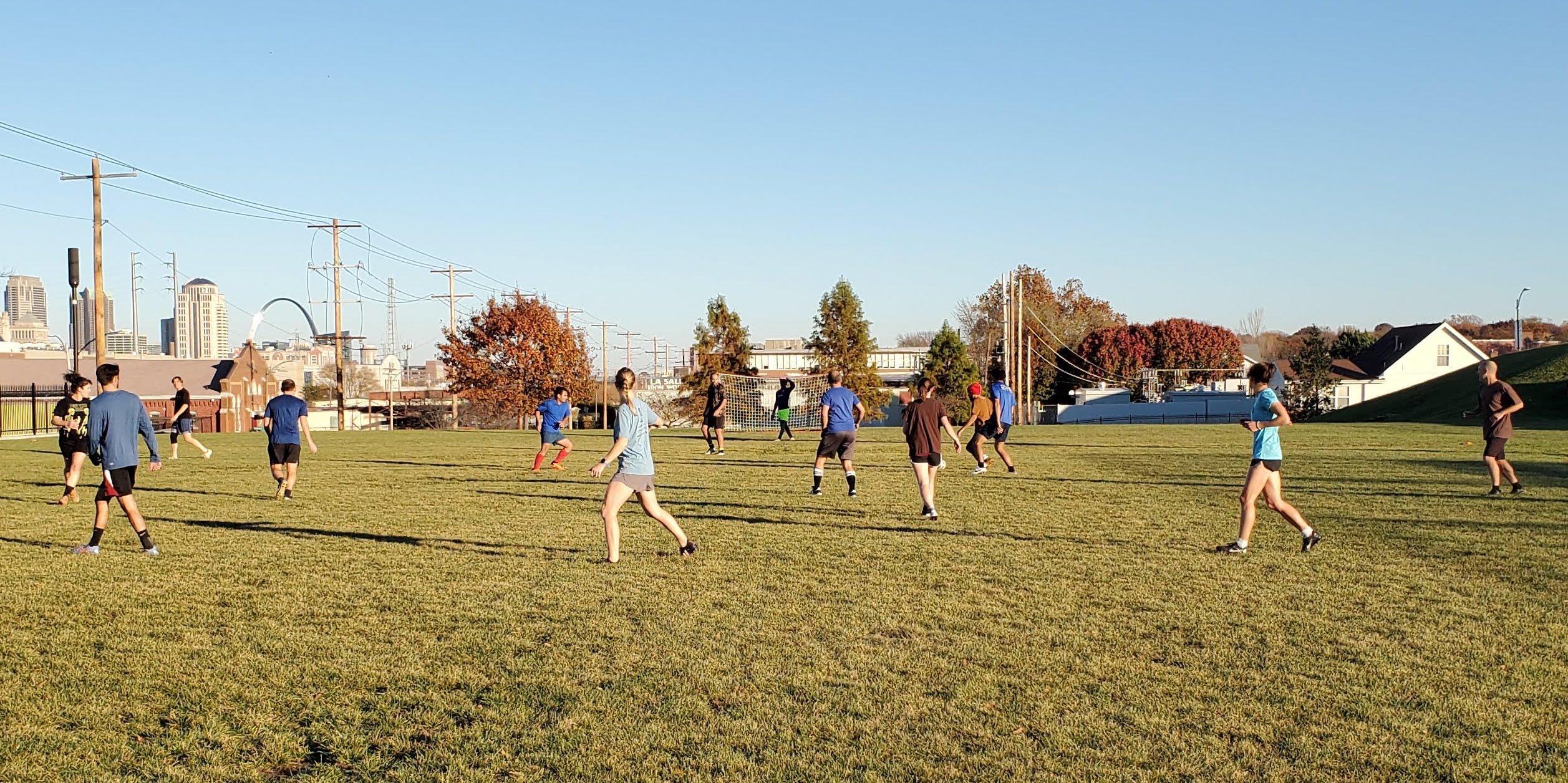 People playing Soccer in a field